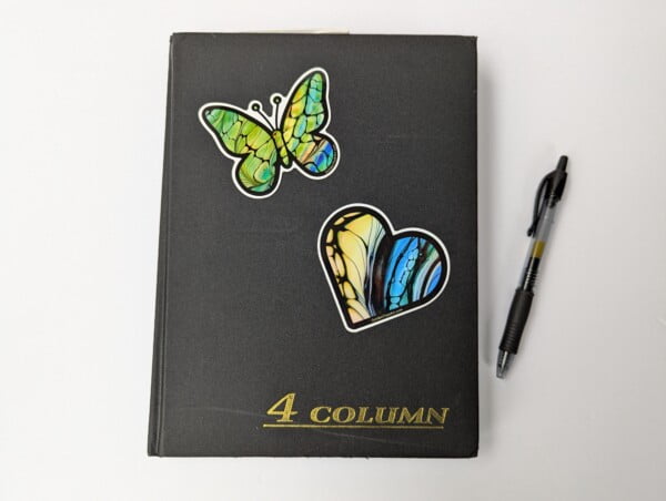 flat lay with a sample of vinyl stickers on a journal